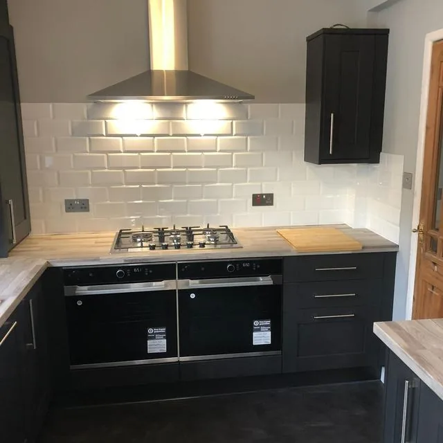 A kitchen with fitted units, worktop and sink