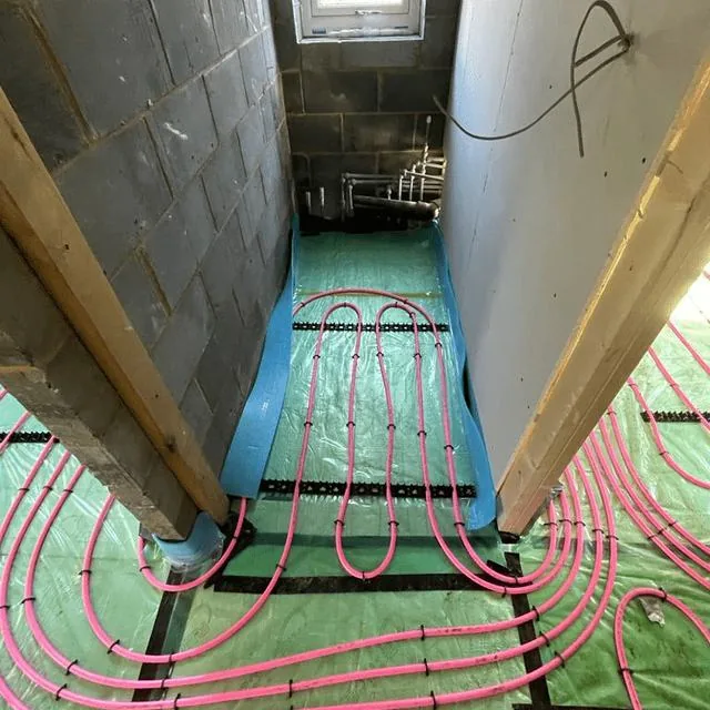 Underfloor heating loops running through a doorway before screeding