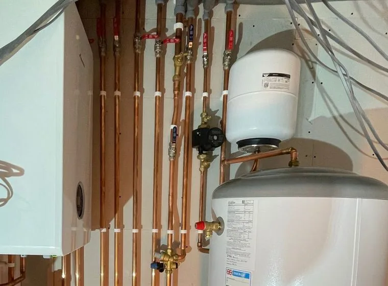 An unvented hot water cylinder with an expansion vessel and pipework