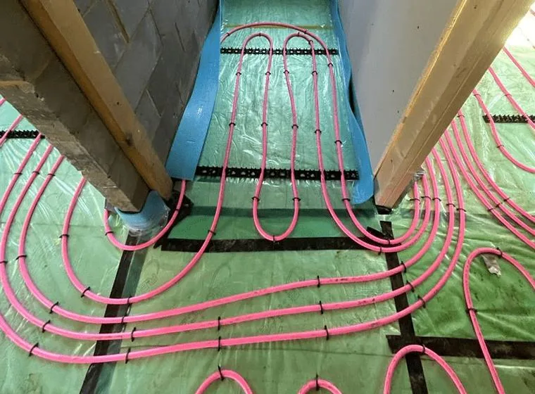 Underfloor heating pipe loops laid on insulation before a screed pour